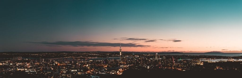 a panorama of auckland city at sunrise taken from mount eden