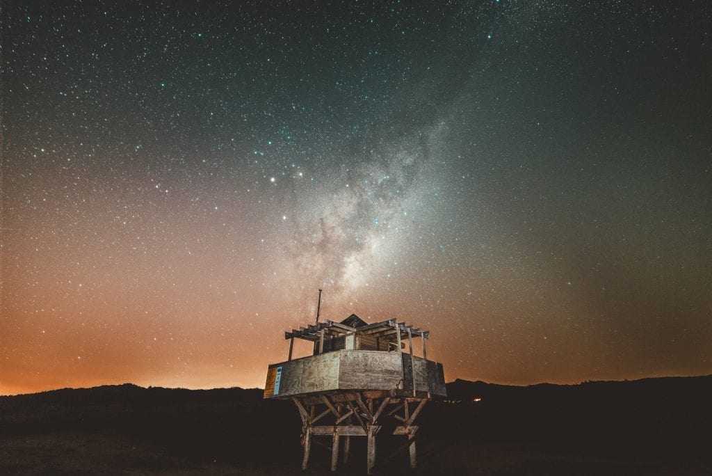 the milky way rising over the bethells te henga surf lifesaving house